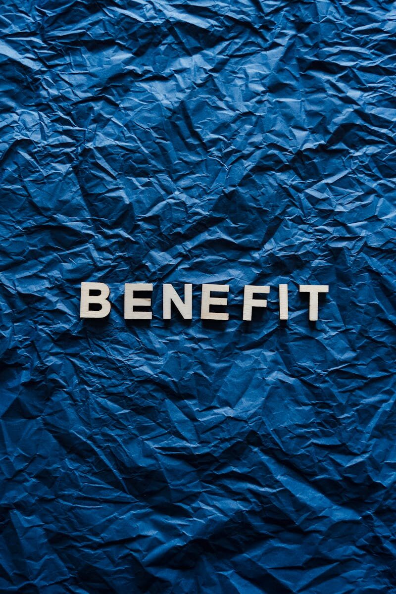 The word 'Benefit' displayed on crumpled blue paper, ideal for concepts.